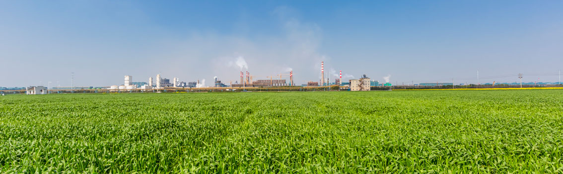 Industrial zone - surrounded by green gras and blue sky